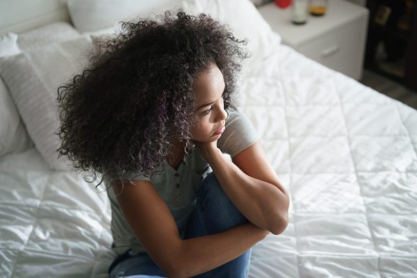 woman sitting in bed feeling depressed