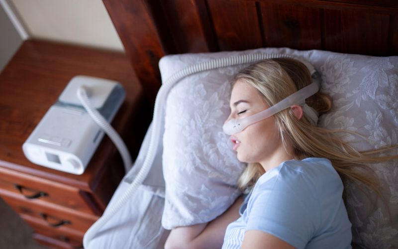 woman sleeping with CPAP mask
