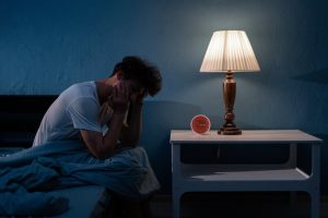 man sitting on bed